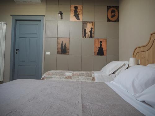 a bedroom with two beds and a tiled wall at B&B Antique Maison in Soave