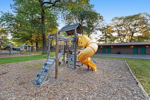 a playground with a slide in a park at Chanticleer Inn: Hudson House in Eagle River
