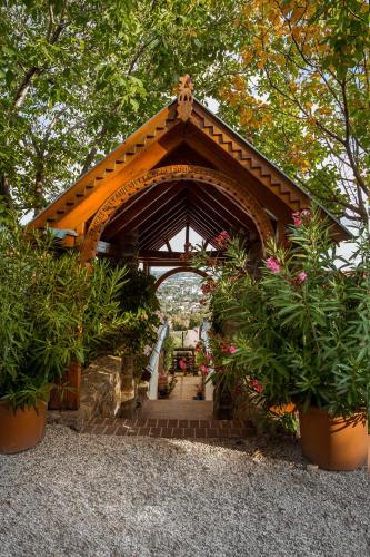 a pavilion with plants in pots in a garden at Bagoly Pincesor Fogado in Pécs