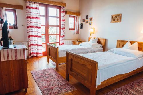 a bedroom with two beds and a window at Bagoly Pincesor Fogado in Pécs