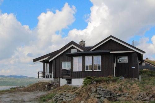 a house sitting on top of a hill at Veslehytta - cabin 1050 moh via amazing view and ambiance in Ål