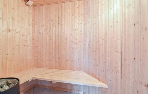 a wooden sauna with a bench in a room at 3 Bedroom Nice Apartment In Bogense in Bogense
