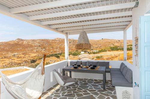 a patio with a table and chairs and a view at Harmony Luxury Villas Naxos in Naxos Chora
