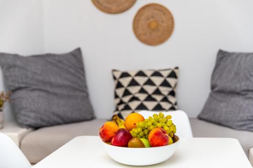 a bowl of fruit on a table in a living room at Harmony Luxury Villas Naxos in Naxos Chora