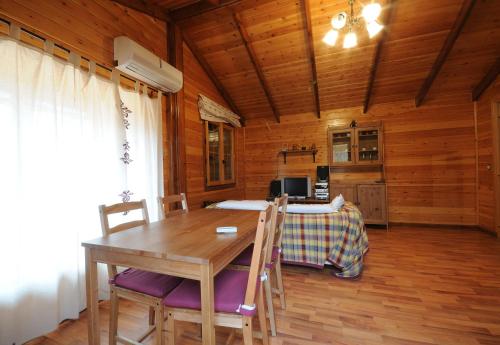 a wooden dining room with a wooden table and chairs at El Mirador De La Moraña in Hernansancho