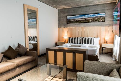 a bedroom with a bed and a living room at Keo Hotel - Ovalle Casino Resort in Ovalle