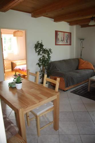 a living room with a table and a couch at Chalupa u Pilných in Kaplice