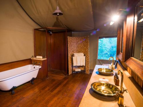 a large bathroom with a tub and a sink at aha Thakadu River Camp in Madikwe Game Reserve