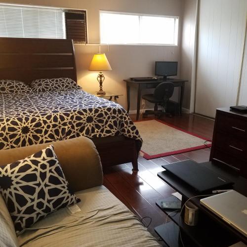 a bedroom with two beds and a desk with a computer at Woodland Hills BEST Priced Room in Woodland Hills