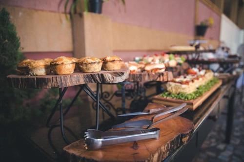 a buffet line with pastries and muffins on display at Café Palace Hotel in Três Pontas