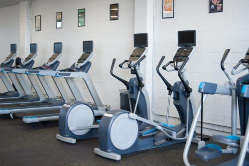 a row of cardio machines in a gym at Hotel Saint George in Marfa