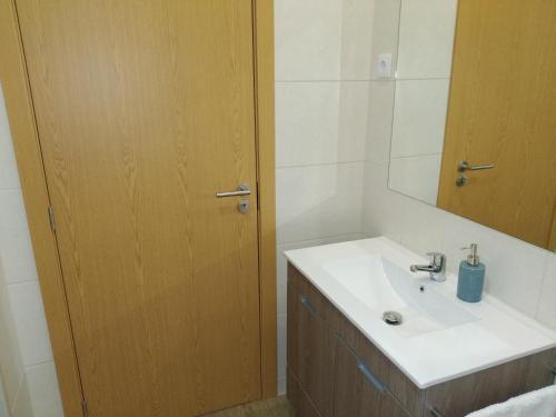 a bathroom with a sink and a mirror at Casa Do Boteco in Santa Marta de Penaguião