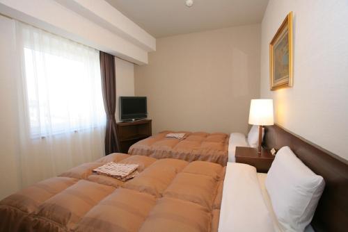 En eller flere senge i et værelse på Hotel Route-inn Koriyama Inter