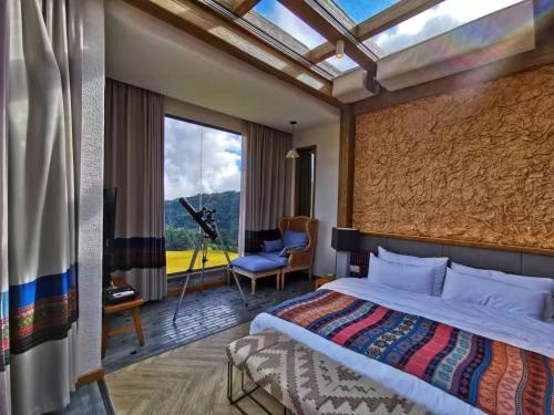 a bedroom with a bed and a large window at The Twelve Manor•Terraces Lodge in Yuanyang