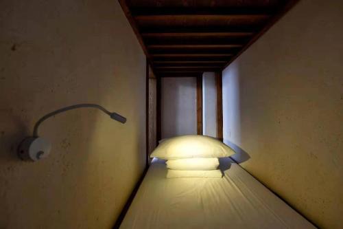 a light in a room with a lamp on the wall at The Twelve Manor•Terraces Lodge in Yuanyang