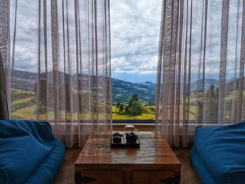 a room with a table and a large window with a view at The Twelve Manor•Terraces Lodge in Yuanyang