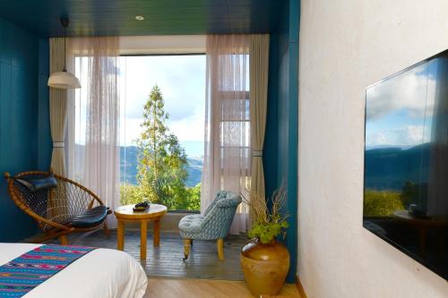 a bedroom with a bed and a large window at The Twelve Manor•Terraces Lodge in Yuanyang