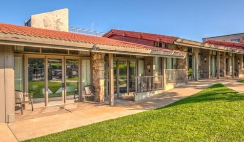 a building with a lawn in front of it at Lodge of Four Seasons Golf Resort, Marina & Spa in Lake Ozark