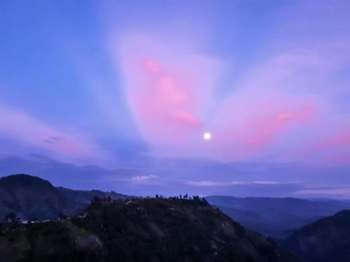 a view of a mountain with the moon in the sky at Ecohotel Bordones in Isnos