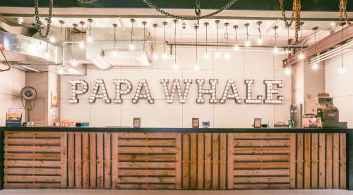 a restaurant with aapa whale sign on the wall at Hotel PaPa Whale in Taipei