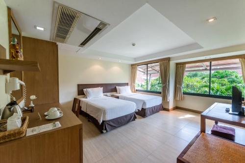 Kama o mga kama sa kuwarto sa Hotel Tropicana Pattaya