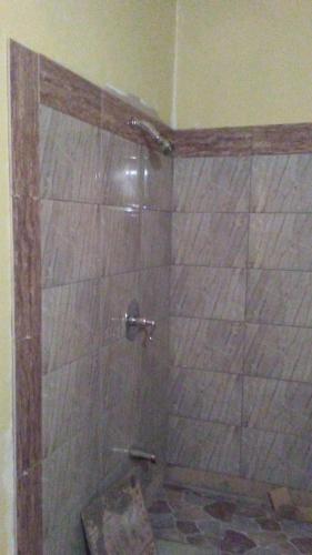 a shower in a bathroom with a glass door at CASTLE VIEW VILLA in Diamond