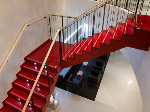 a red staircase with red seats in a building at EA Hotel Tereziánský dvůr in Hradec Králové
