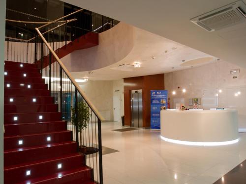 a staircase in a building with a lobby at EA Hotel Tereziánský dvůr in Hradec Králové