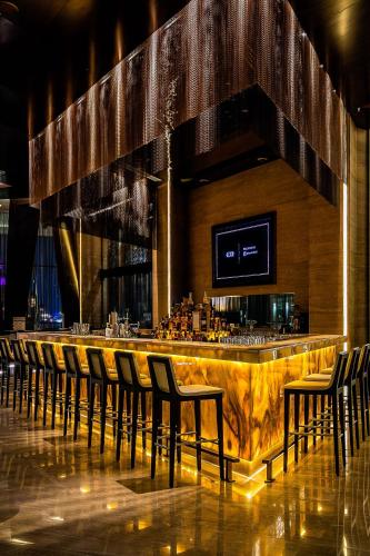 a bar in a restaurant with a bunch of chairs at Grand Hyatt Abu Dhabi Hotel & Residences Emirates Pearl in Abu Dhabi