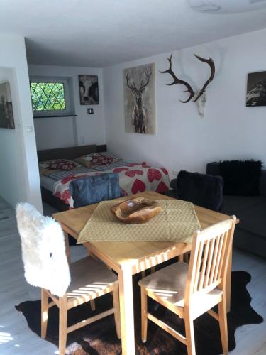 a room with a table and chairs and a bed at Posthof 33 in Kitzbühel