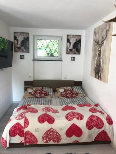 a bedroom with two beds with red and white blankets at Posthof 33 in Kitzbühel