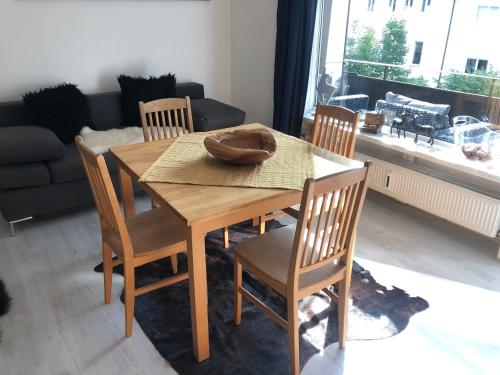 a wooden table and chairs in a living room at Posthof 33 in Kitzbühel
