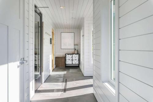 a hallway of a home with white walls and white floors at UpValley Inn & Hot Springs, Ascend Hotel Collection in Calistoga