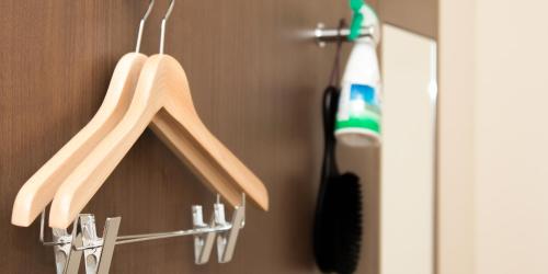 a pair of wooden hangers are hanging in a bathroom at Hotel Wakamatsu Excel in Isesaki