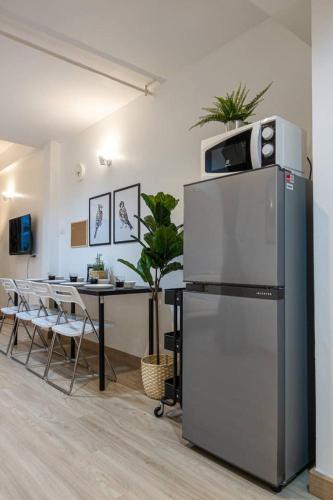 a kitchen with a refrigerator and a table with chairs at B3 Cosy Studio /5 guests/ Near MRT/full kitchen in Bangkok