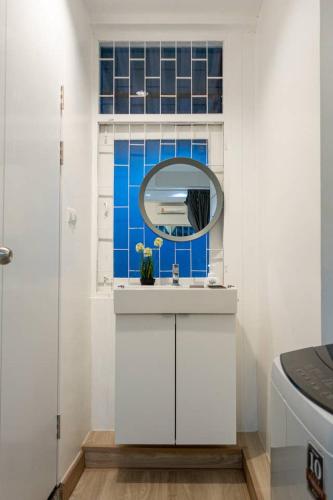 a bathroom with a sink and a mirror at B3 Cosy Studio /5 guests/ Near MRT/full kitchen in Bangkok