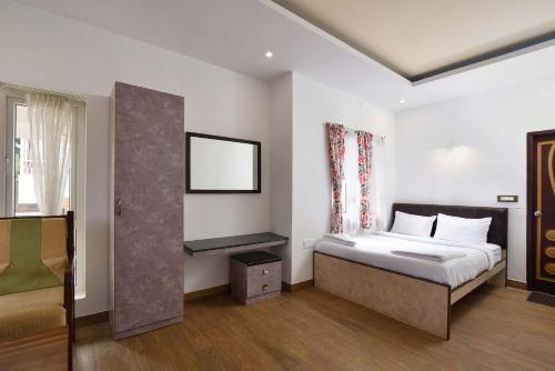 a bedroom with a bed and a window at Villa Sullivan by VEO - Part of StayVista in Ooty