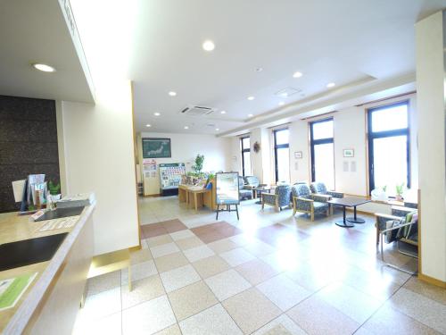a lobby with chairs and tables in a building at Hotel Route-Inn Kani in Kani