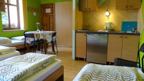 a room with a kitchen and a table with a tableablish at Noclegi "Marek i Karolina" in Cieszyn