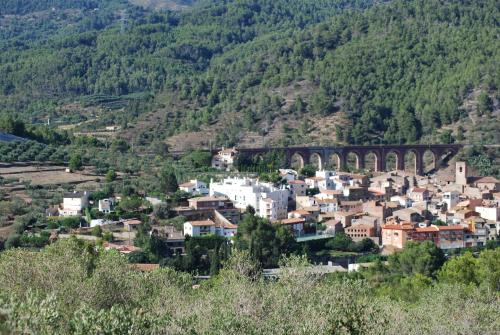 a small town with a bridge in a mountain at Apartamentos Les Moreres in Duesaigües