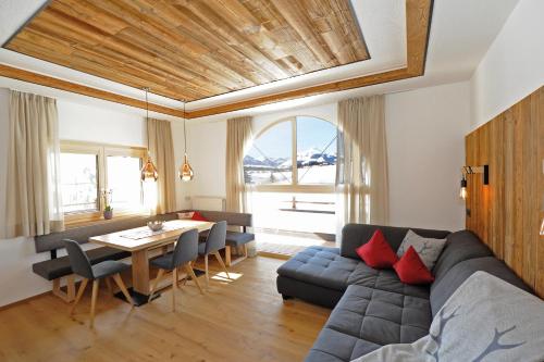 a living room with a couch and a table at Ferienwohnungen Familie Niedermoser Stefan in Sankt Jakob in Haus