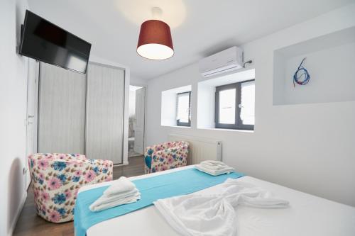 a room with a table and two chairs at Stanford Aparthotel in Bucharest