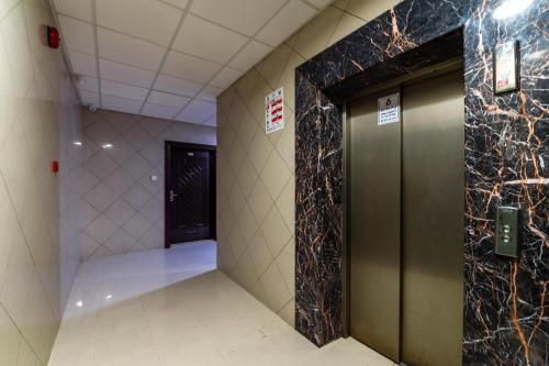 a hallway with a elevator in a building at Al Reem Hotel Apartments in Sharjah