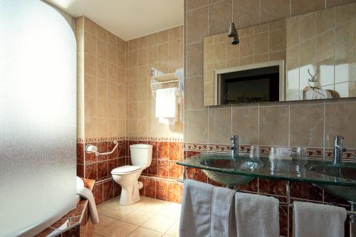 a bathroom with a sink and a toilet at Best Western Central Hotel in Tours