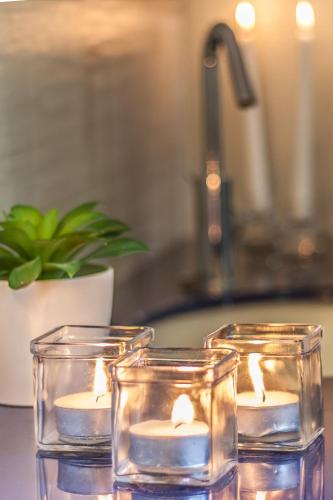 two candles in glass containers on a counter at Locanda Bella Fra in Blevio