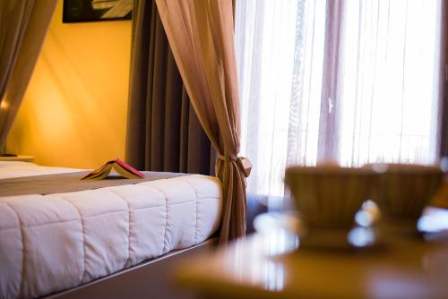 a bedroom with a bed and a window with curtains at Elia Potie in Chania Town