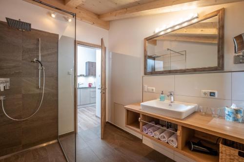 a bathroom with a sink and a shower at Beim Neuner - Zeit zu zweit in Oberaudorf
