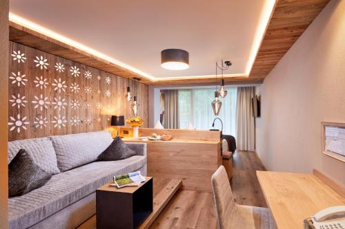 a living room with a couch and a table at Hotel Tirol in Ischgl