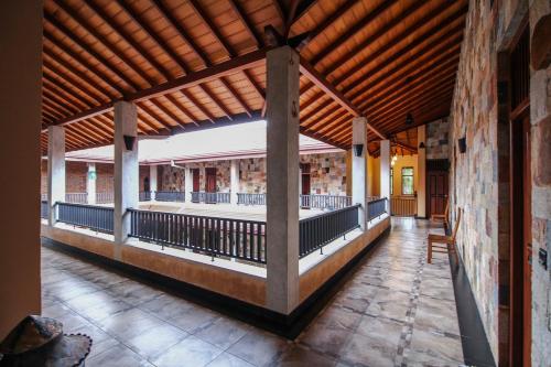 a porch of a building with a wooden roof at Jasmin Villa Ayurveda Resort in Negombo