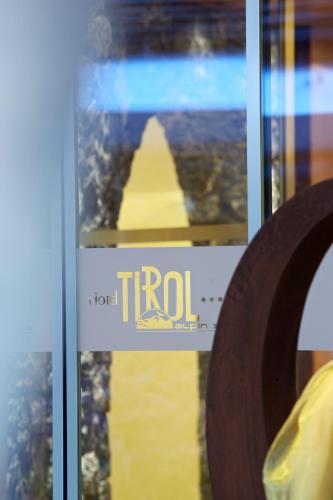 a sign in a window with a tril at Hotel Tirol in Ischgl